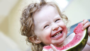 A Little Girl Finishing a Slice of Watermelon